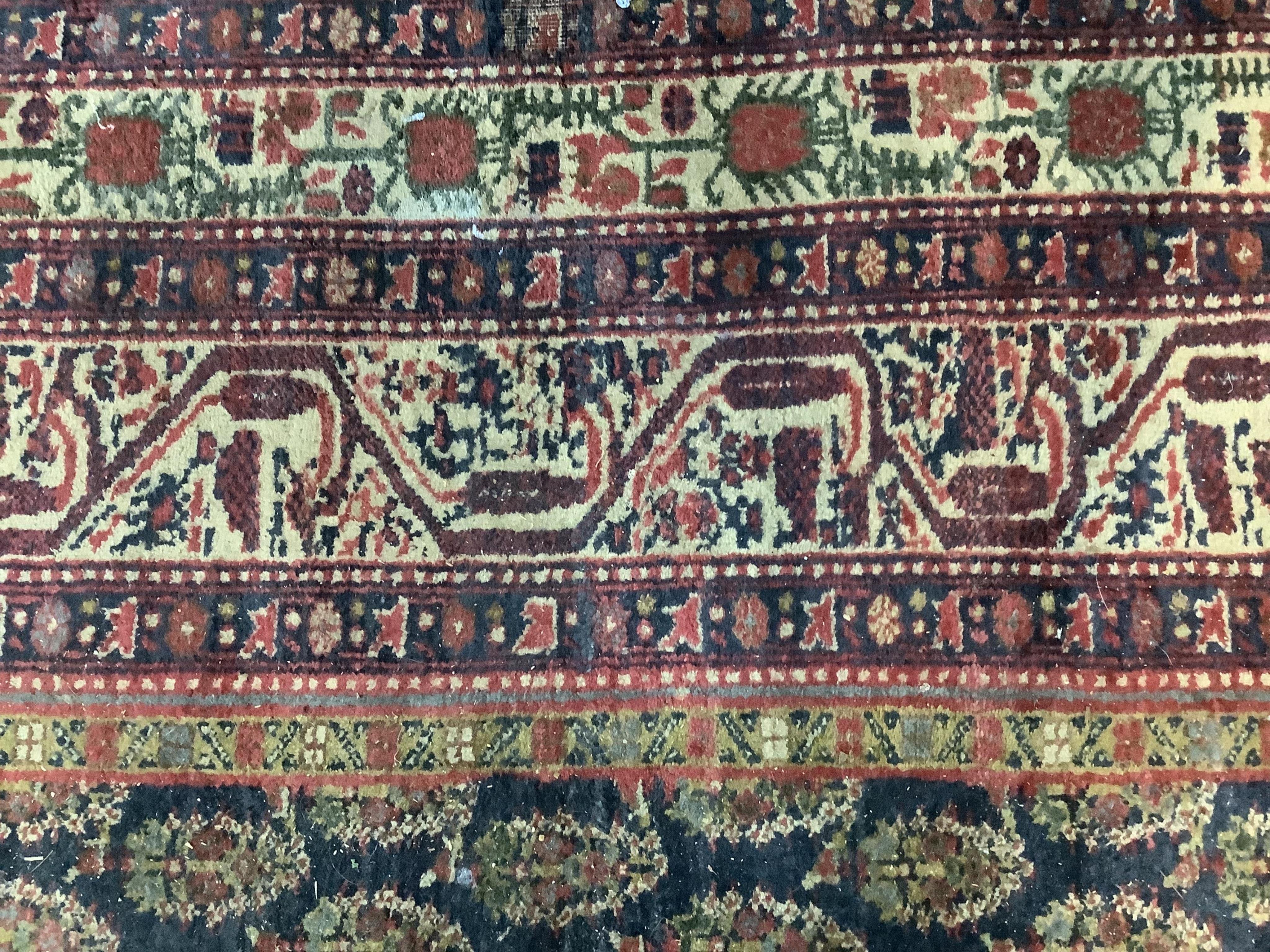 A Serabend blue ground boteh carpet, approximately 406 x 334cm. Condition - poor